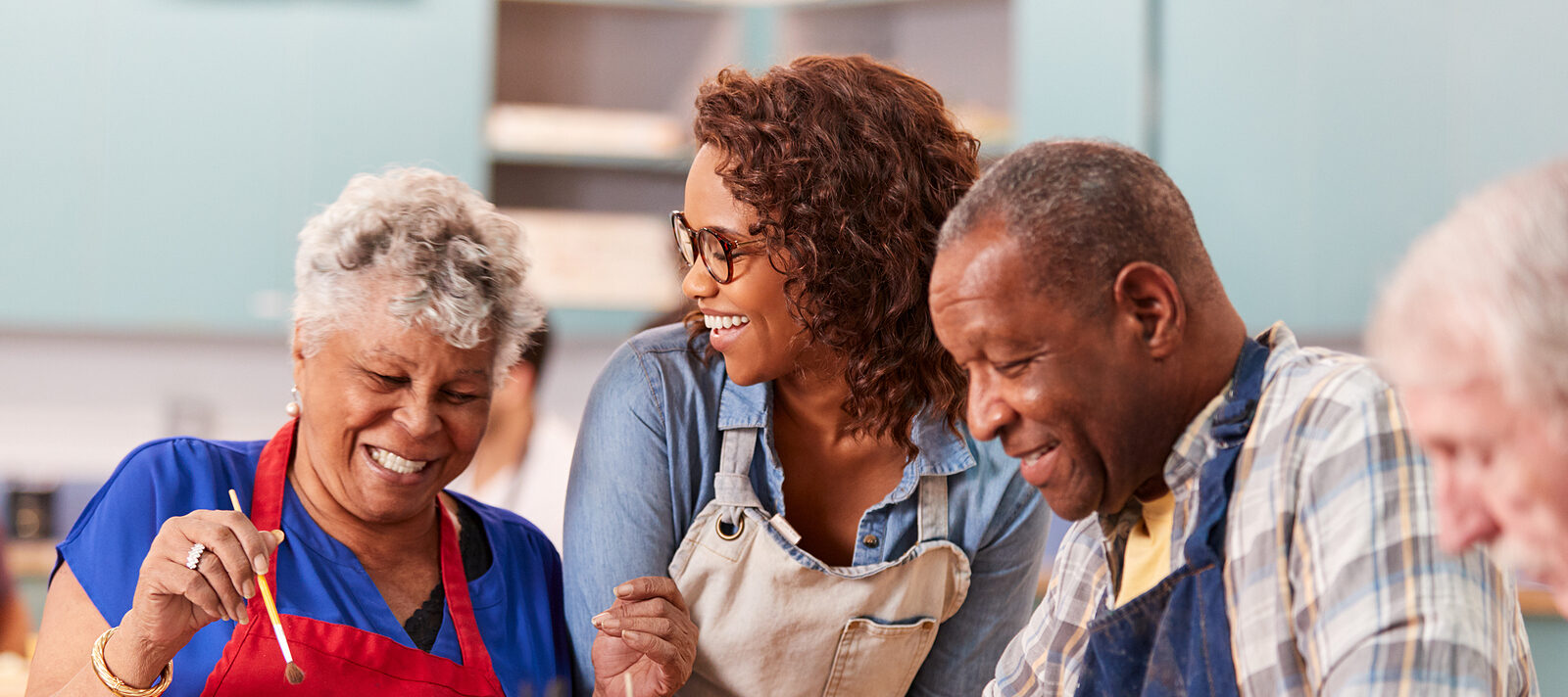 Group Of Retired Seniors Attending Art Class In Community Centre