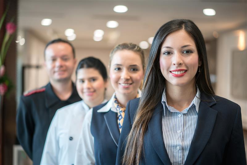 image of employees standing and smiling